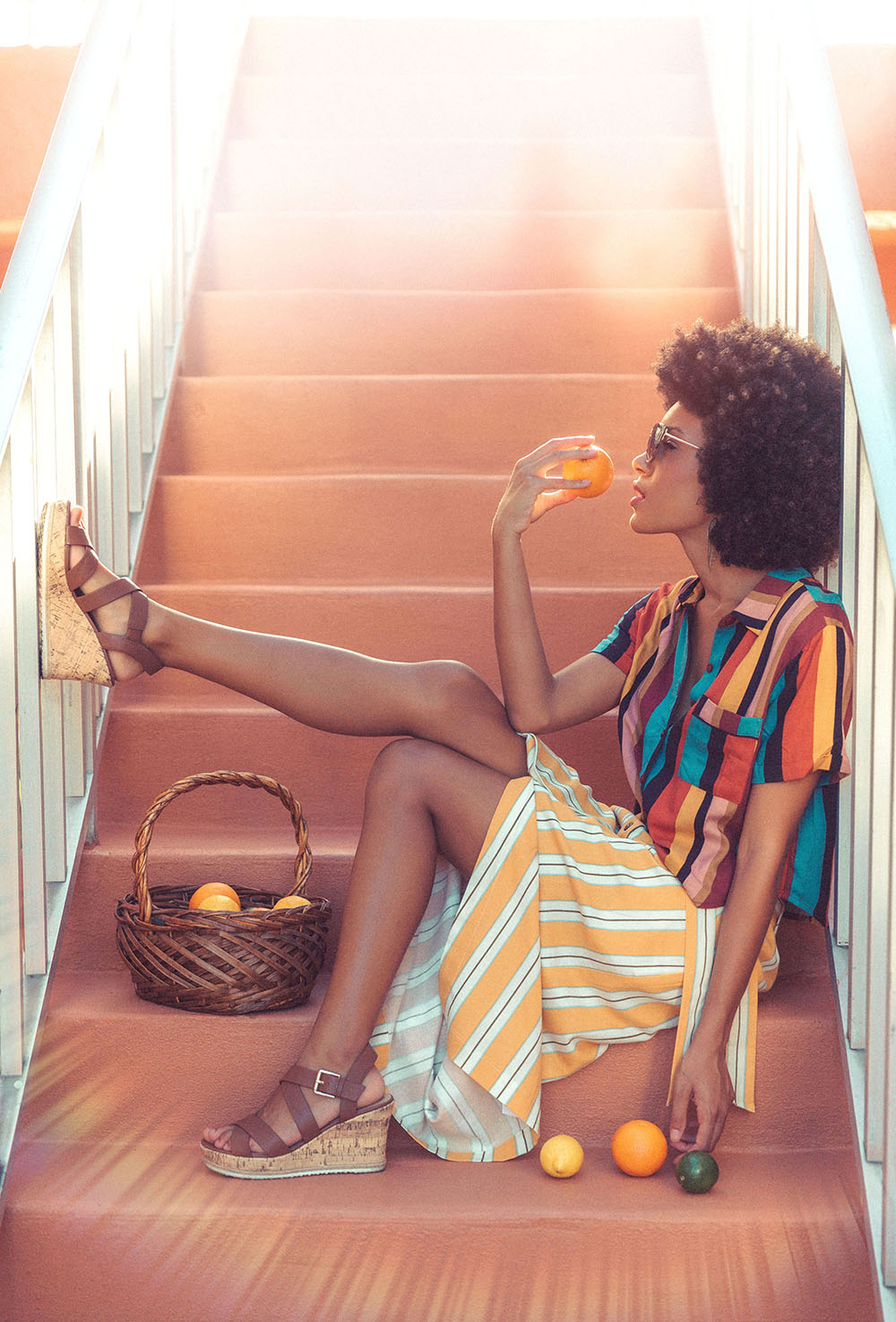 Naples Branding Photographer, woman sitting on stairs eating an orange