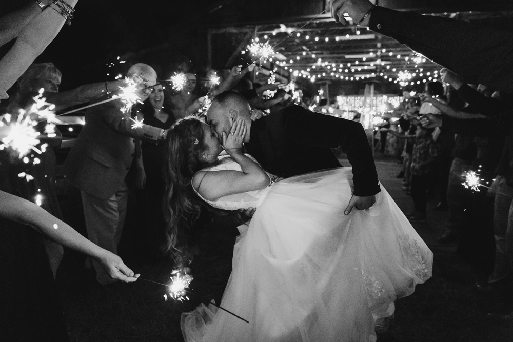 Naples Wedding Photographer, groom dipping bride as they leave the reception